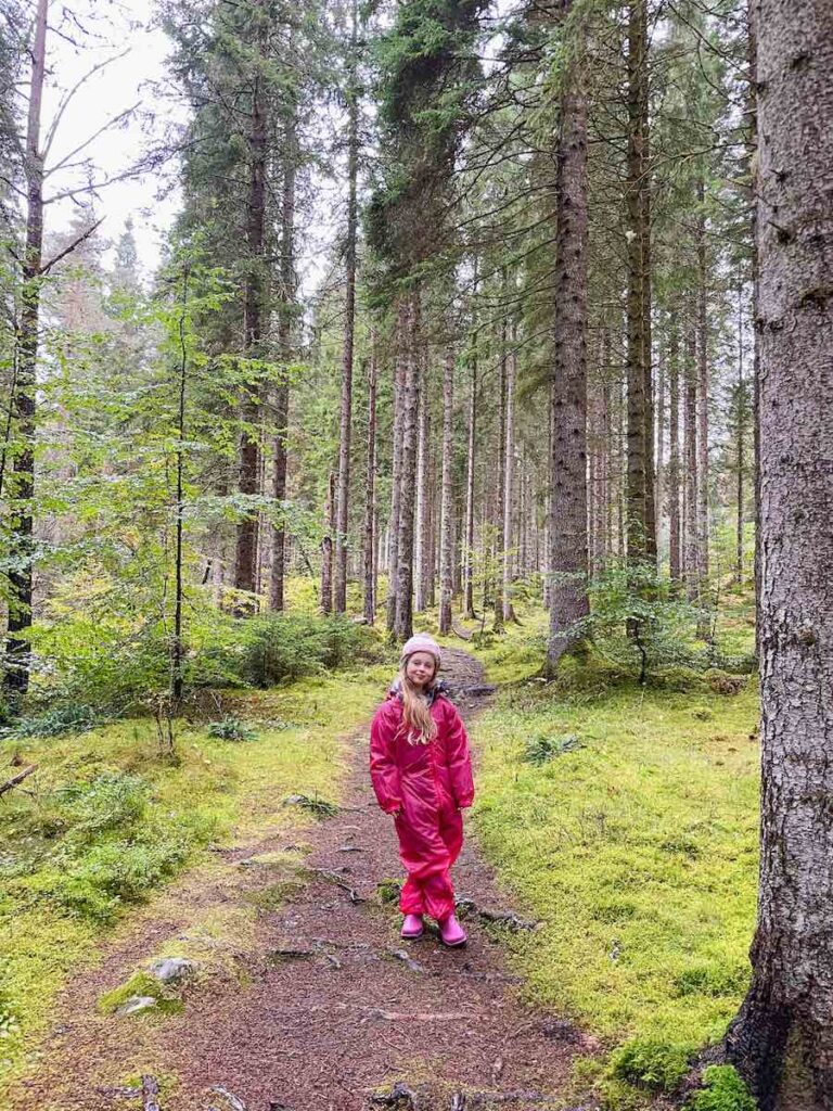 Young girl in pink coat walking the Allt na Calliche Trail