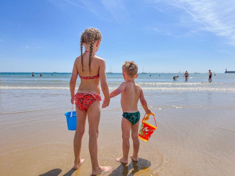 Siblings stand hand in hand on Les Sables D Olonne Beach