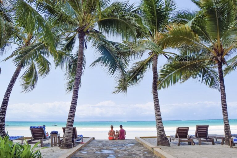 Family sit at the beach at Blue Marlin Beach Hotel