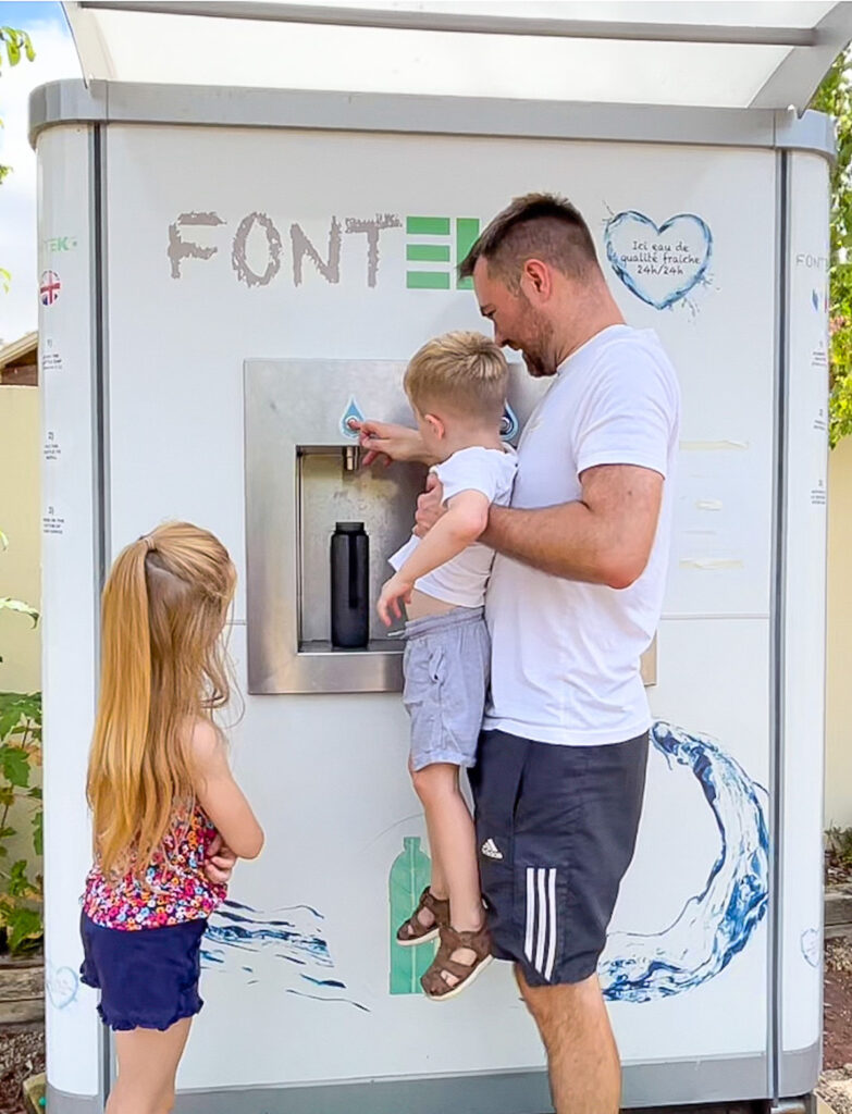 Family use the Eco water fountain at Camping La Garangeoire