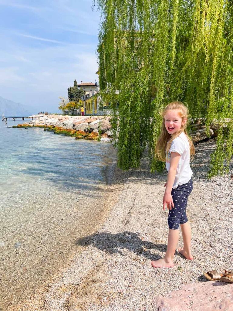 Child stands on the edge of Lake Garda