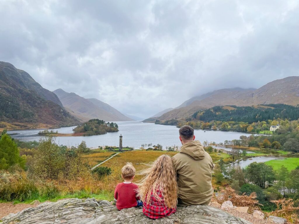 Fathern and his two children look out across Loch Shiel