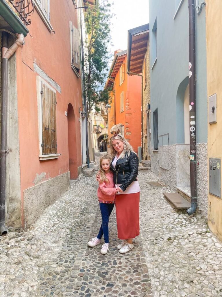 Mother and daughter stand in Malcesine street, Lake Garda