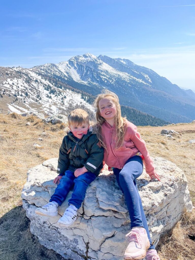 Siblings sit on Monte Baldo Mountain range