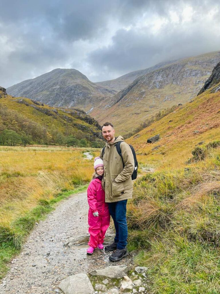 Father and daughter stand at Steall Falls Nevis Gorge