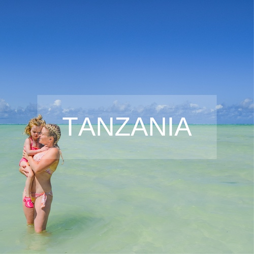 Mother and daughter stand in aqua sea in Zanzibar