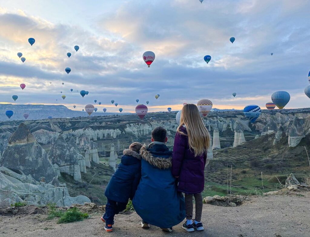 Family watch the hot air balloons in Cappadocia Love Valley