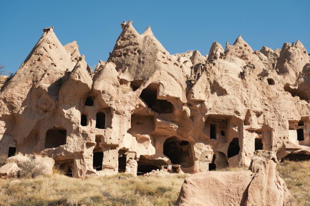 a group of buildings made of rocks in the desert