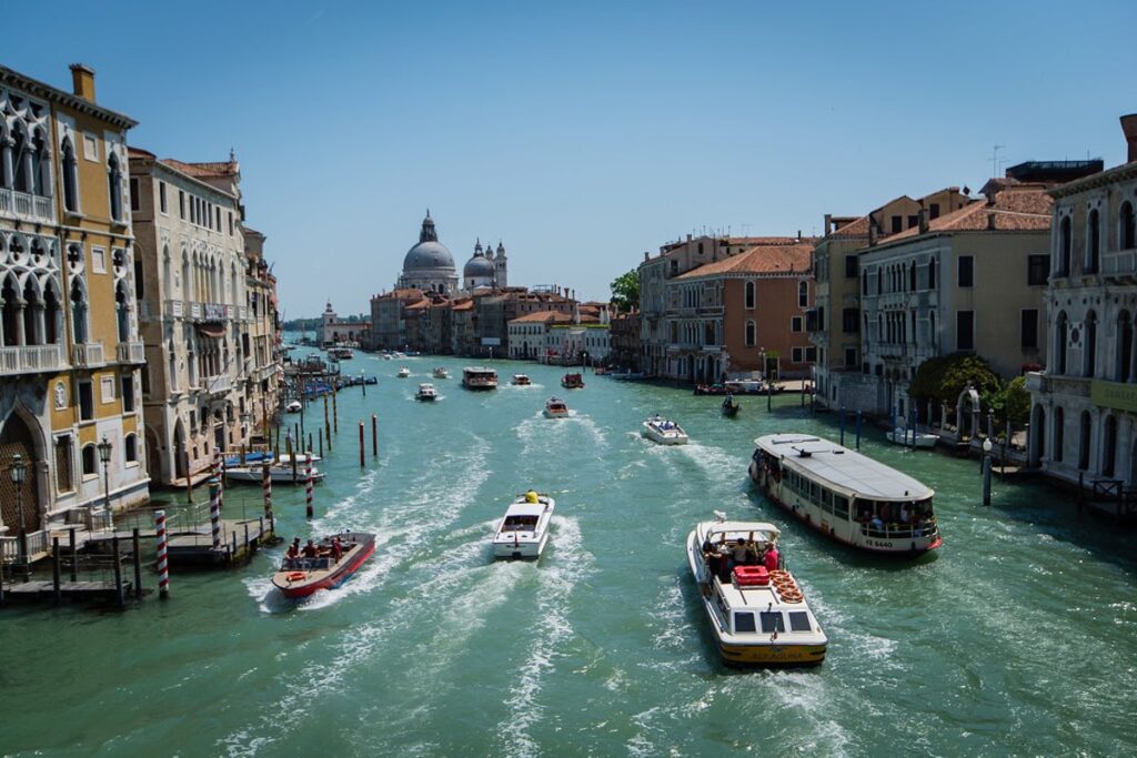 Boats floating along a Venice canal, perfect for exploring the city with kids