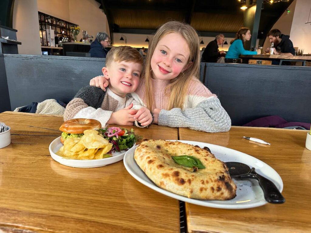 Two children enjoying a meal at Gasta Port Righ restaurant, Isle of Skye, Scotland.