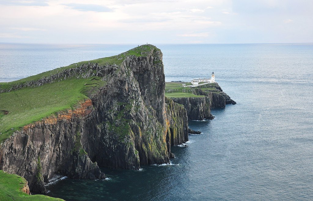 Walking trail leading to Neist Point Lighthouse on the Isle of Skye, Scotland, with coastal cliffs and ocean views.