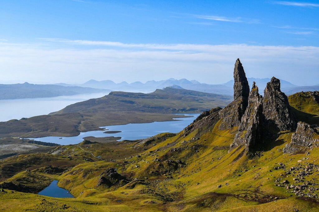 The Old Man of Storr rock formation on the Isle of Skye, Scotland, with dramatic cliffs and surrounding landscape.