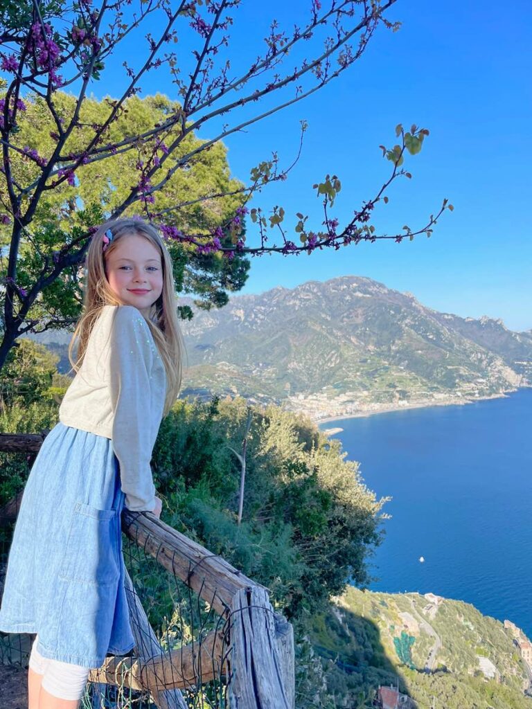 Child looking out from a viewpoint over the Amalfi Coast in Italy.