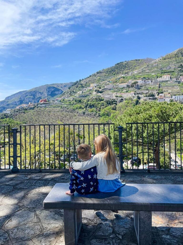 Children sitting in Ravello looking out over terraced hills on the Amalfi Coast.