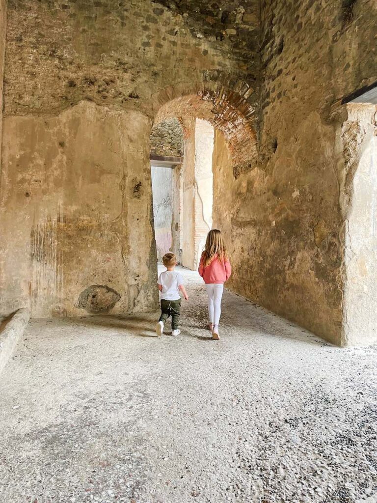 Children exploring the ancient ruins of Pompeii in Italy.
