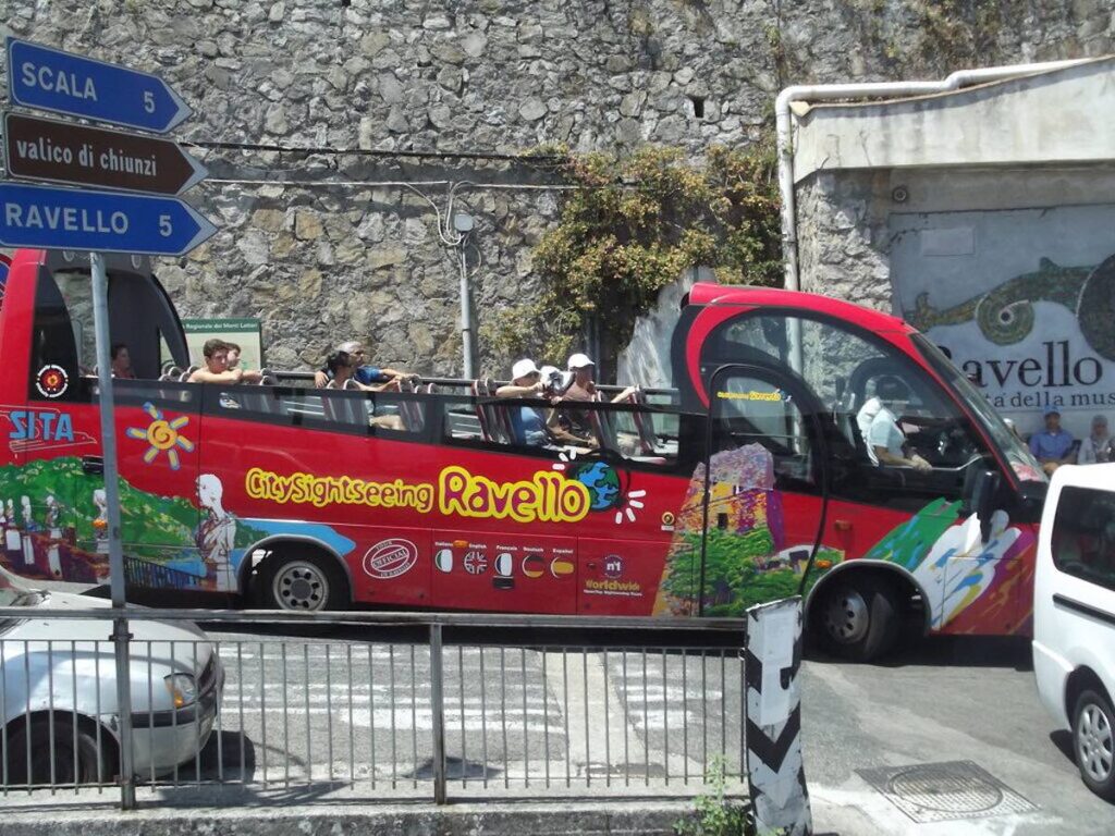 Local bus travelling along the winding coastal road on the Amalfi Coast in Italy.