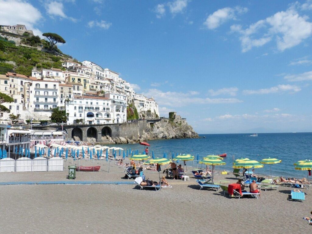 Amalfi beach with sun loungers and sea views in Italy.