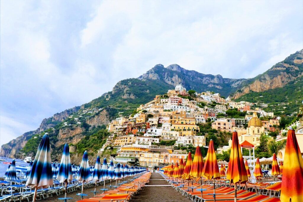 Colourful sun loungers on Positano beach on the Amalfi Coast in Italy.