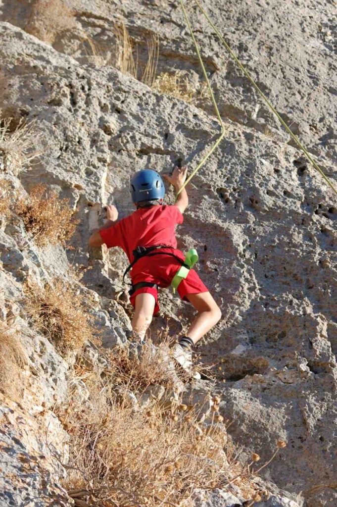 Child rock climbing on Amalfi Coast